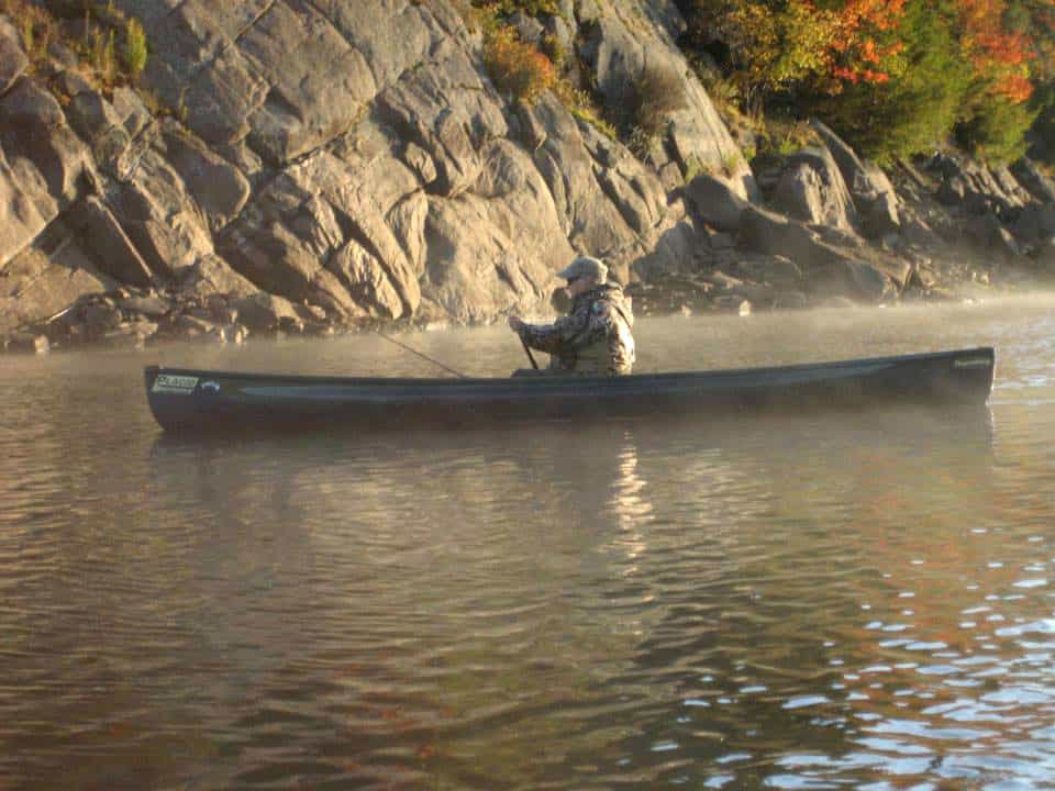 man fishing in Placid Boatworks lightweight pack canoe