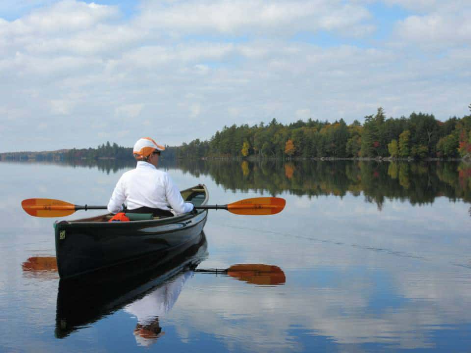 woman enjoying view in her Placid Boatworks lightweight pack canoe
