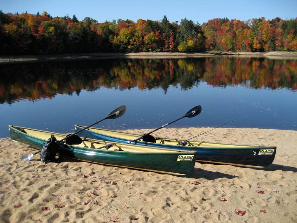 Placid Boatworks lightweight pack canoes and paddles on beach