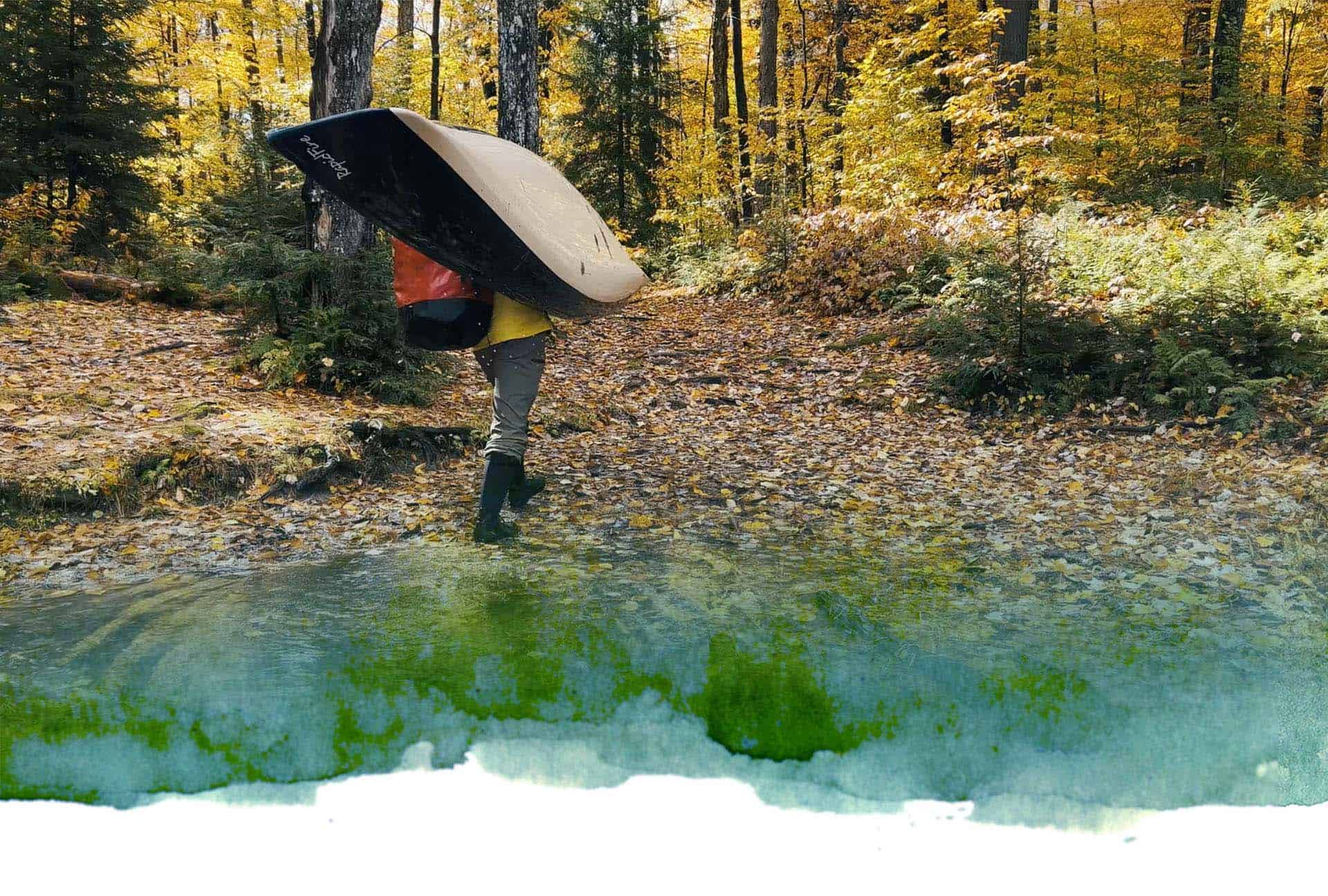 Man carrying Placid Boatworks boat through woods