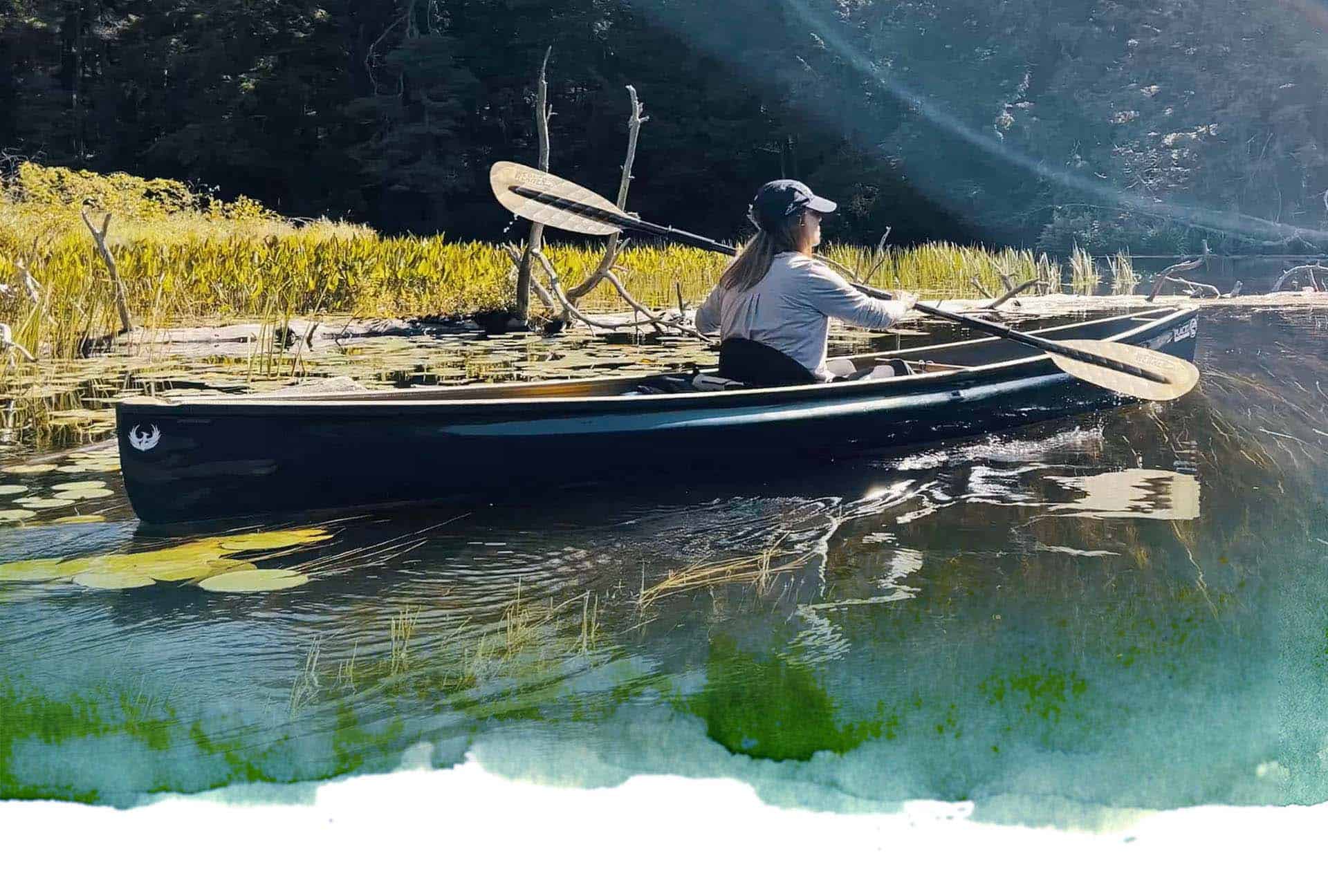 Woman paddling in Placid Boatworks boat