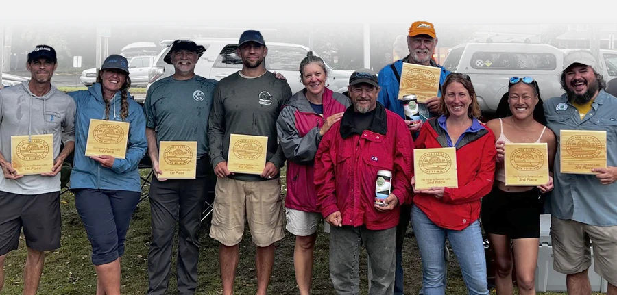 Group of Men and Women Holding Adirondack Canoe Classic 90-Miler Plaques